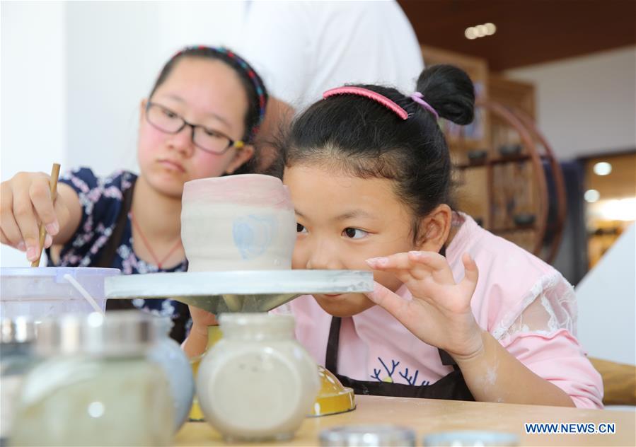 Children Learn To Make Ceramics During National Day Holiday 